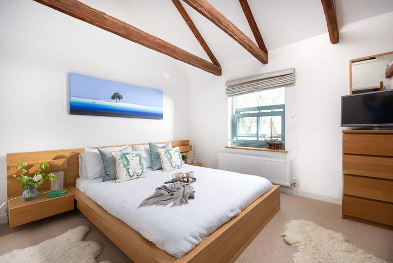 The Old Smokehouse has three light and airy bedrooms and this one enjoys views out over the harbour