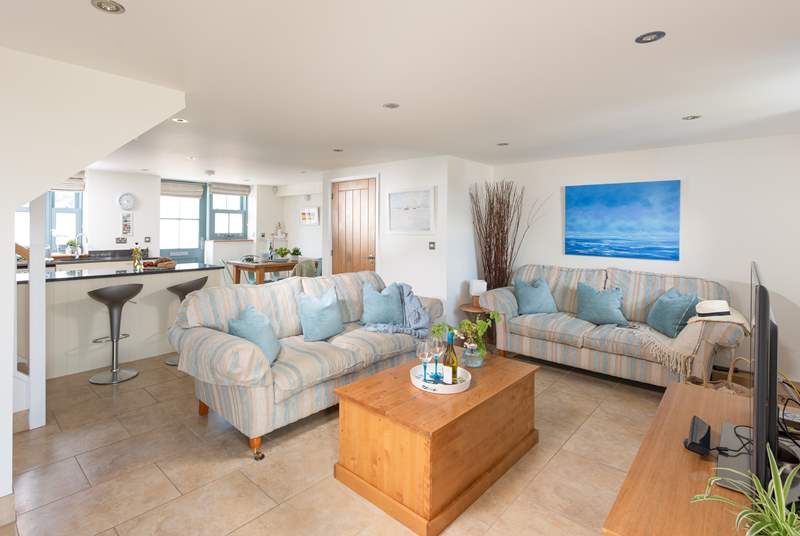 The decor of the open plan living-room perfectly complements the coastal location 