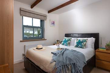 Snuggle up under the covers in the double bed in bedroom two