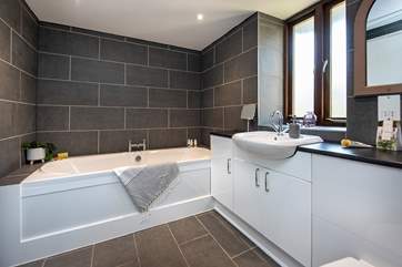 Enjoy a relaxing soak in the family bathroom.