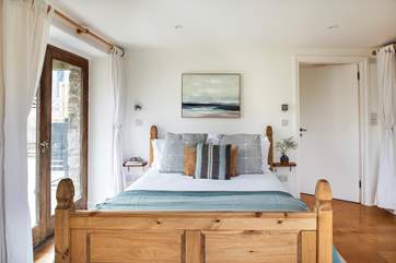 The bedroom on the ground floor has a super comfy king-size bed.