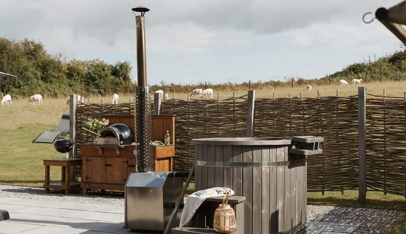 And the outside space is truly idyllic with a wood-fired hot tub and pizza oven. 