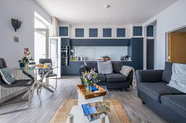 The open plan living area is light, airy and beautifully furnished.