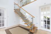 The beautifully designed staircase leads to the first floor.