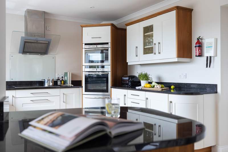 The super sleek kitchen has everything you will need and a washing machine and tumble-drier can be found in the separate utility-room.