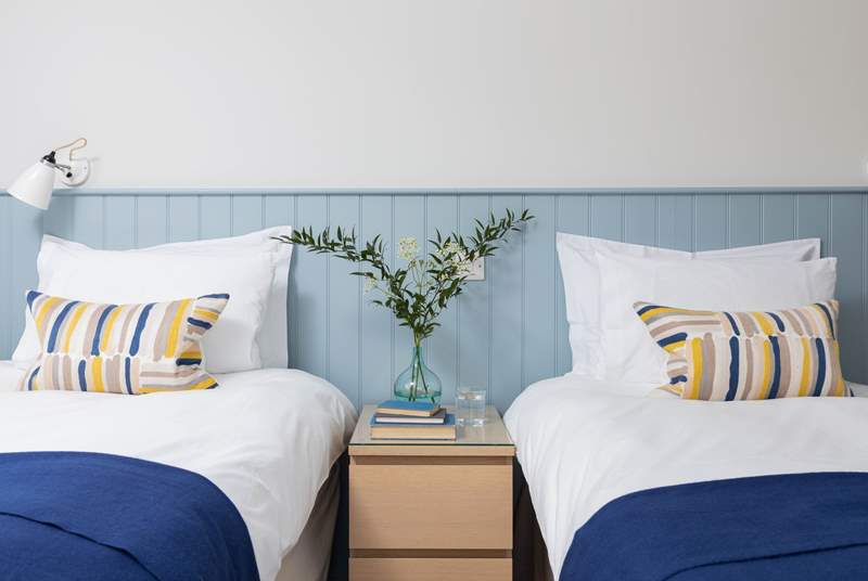 Bedroom 1 is beautifully furnished in cool blue shades.