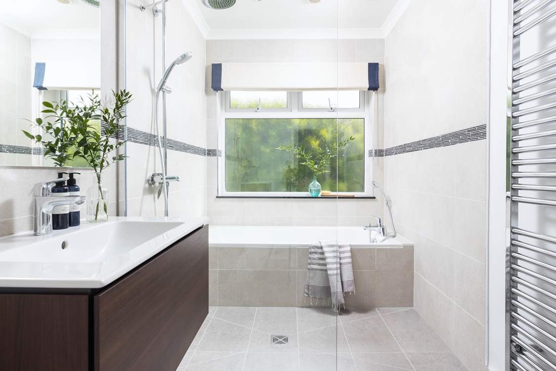 The bathroom on the ground floor has a bath for a long soak after a busy day and a walk-in shower.