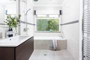 The bathroom on the ground floor has a bath for a long soak after a busy day and a walk-in shower.