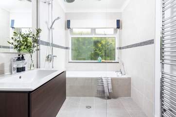 The bathroom on the ground floor has a bath for a long soak after a busy day and a walk-in shower.
