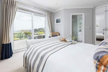 Dreamy bedroom 2 has a king-size bed and patio doors leading out onto the patio.