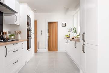 The gorgeous kitchen is well-equipped. Leading off from the kitchen is the downstairs bedroom.
