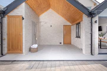 Wow! What a stunning space. The outside hot shower is huge! There is also a cloakroom (with WC and basin) located behind the oak door.