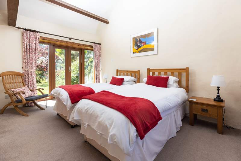 Bedroom 3 has twin beds and a pretty outlook over the garden.