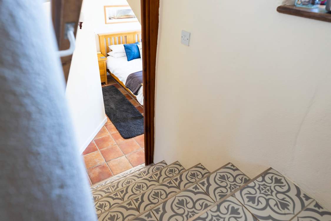Steps lead down from the ground floor to bedroom 1 on the lower ground floor.