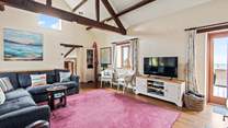 The sitting-room has a Smart TV, perfect for a movie night after a busy beach day.