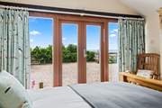 Bedroom 1 is on the lower ground floor with access to the terrace, the ideal place to drink in the view with your morning coffee.