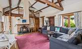 The sitting-room on the ground floor is super cosy and characterful with exposed beams and comfy sofas. - Thumbnail Image