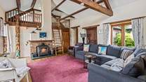 The sitting-room on the ground floor is super cosy and characterful with exposed beams and comfy sofas.