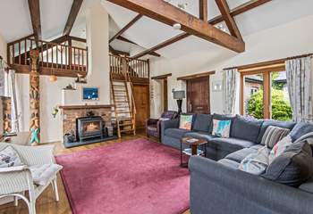 The sitting-room on the ground floor is super cosy and characterful with exposed beams and comfy sofas.