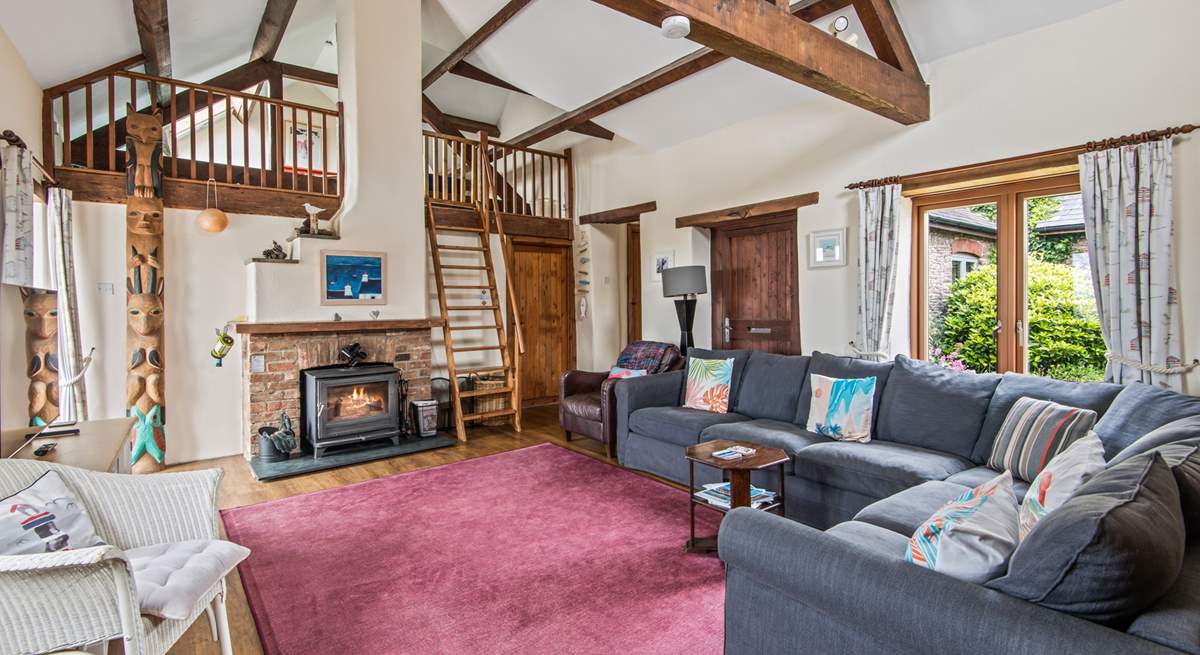 The sitting-room on the ground floor is super cosy and characterful with exposed beams and comfy sofas.