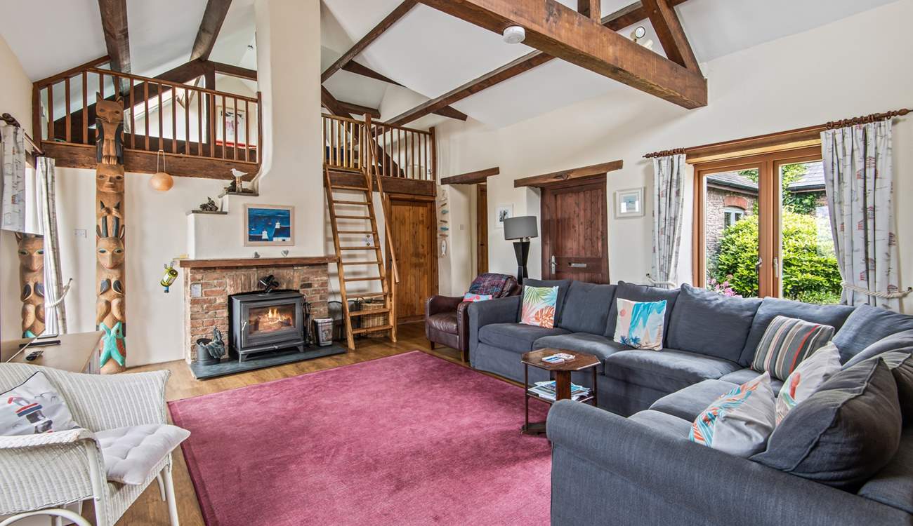 The sitting-room on the ground floor is super cosy and characterful with exposed beams and comfy sofas.