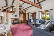The sitting-room on the ground floor is super cosy and characterful with exposed beams and comfy sofas.