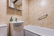 The family bathroom has a bath with shower attachment.