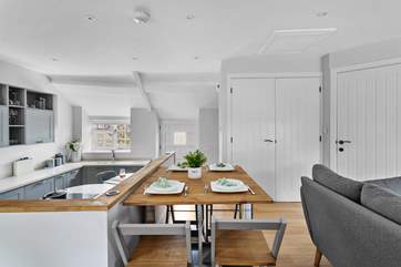 The dining-table can be set up between the open plan kitchen and sitting area.