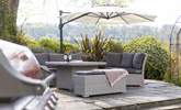 Settle down with a glass of something special in the cosy outdoor seating area. - Thumbnail Image