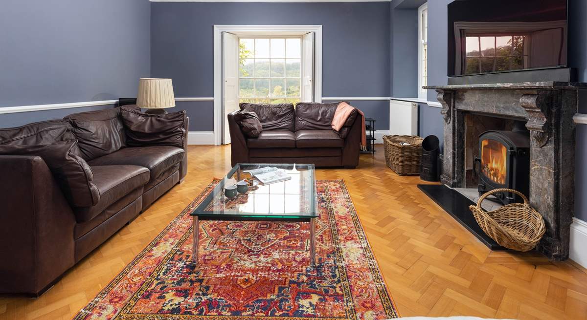 A wonderful Smart TV sits above the second sitting-room's stunning granite fireplace.