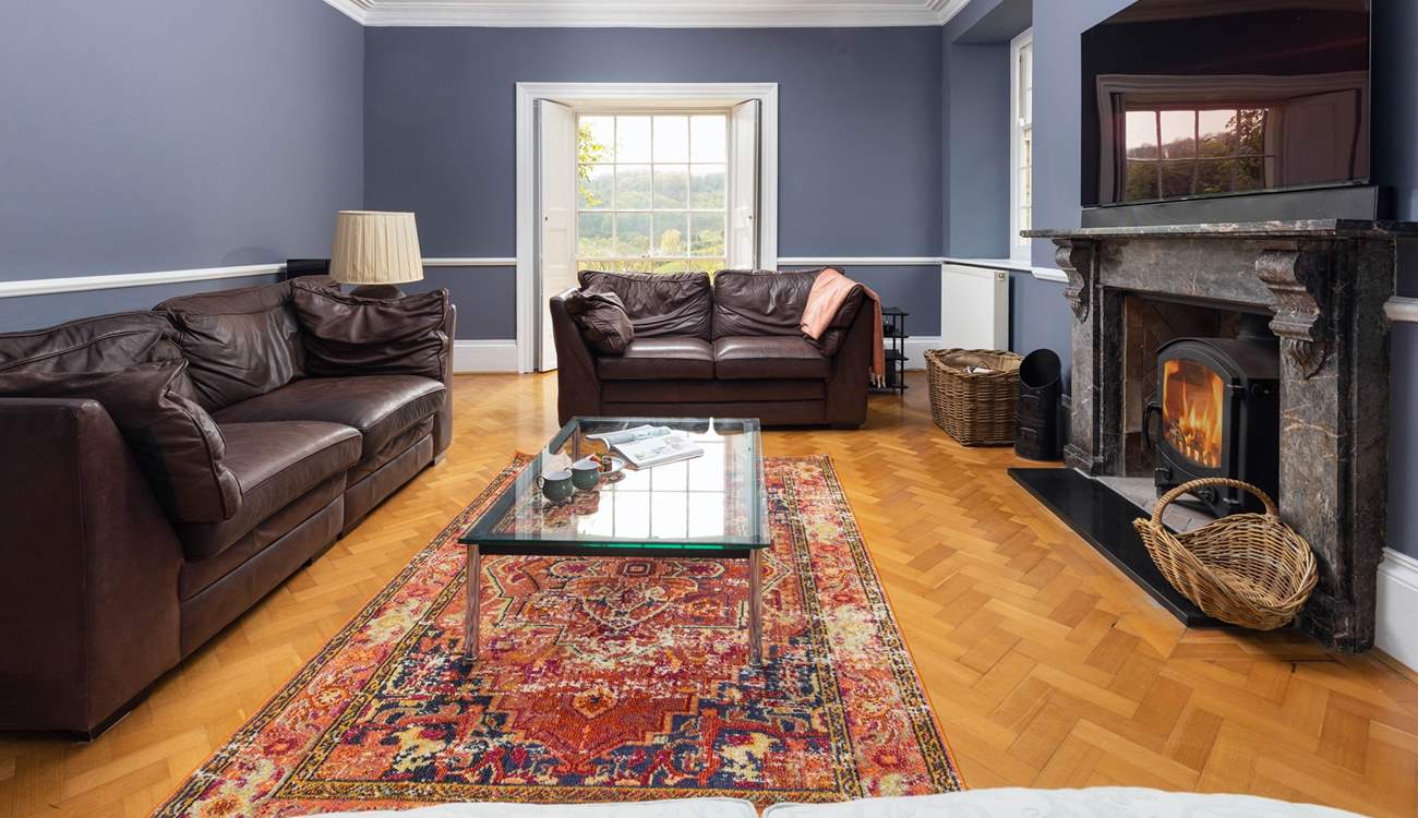 A wonderful Smart TV sits above the second sitting-room's stunning granite fireplace.