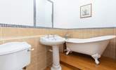 An indulgent free-standing bath sits in the corner of bedroom two's en suite bathroom. - Thumbnail Image