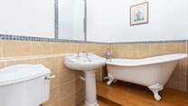 An indulgent free-standing bath sits in the corner of bedroom two's en suite bathroom.