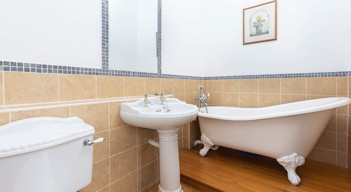 An indulgent free-standing bath sits in the corner of bedroom two's en suite bathroom.