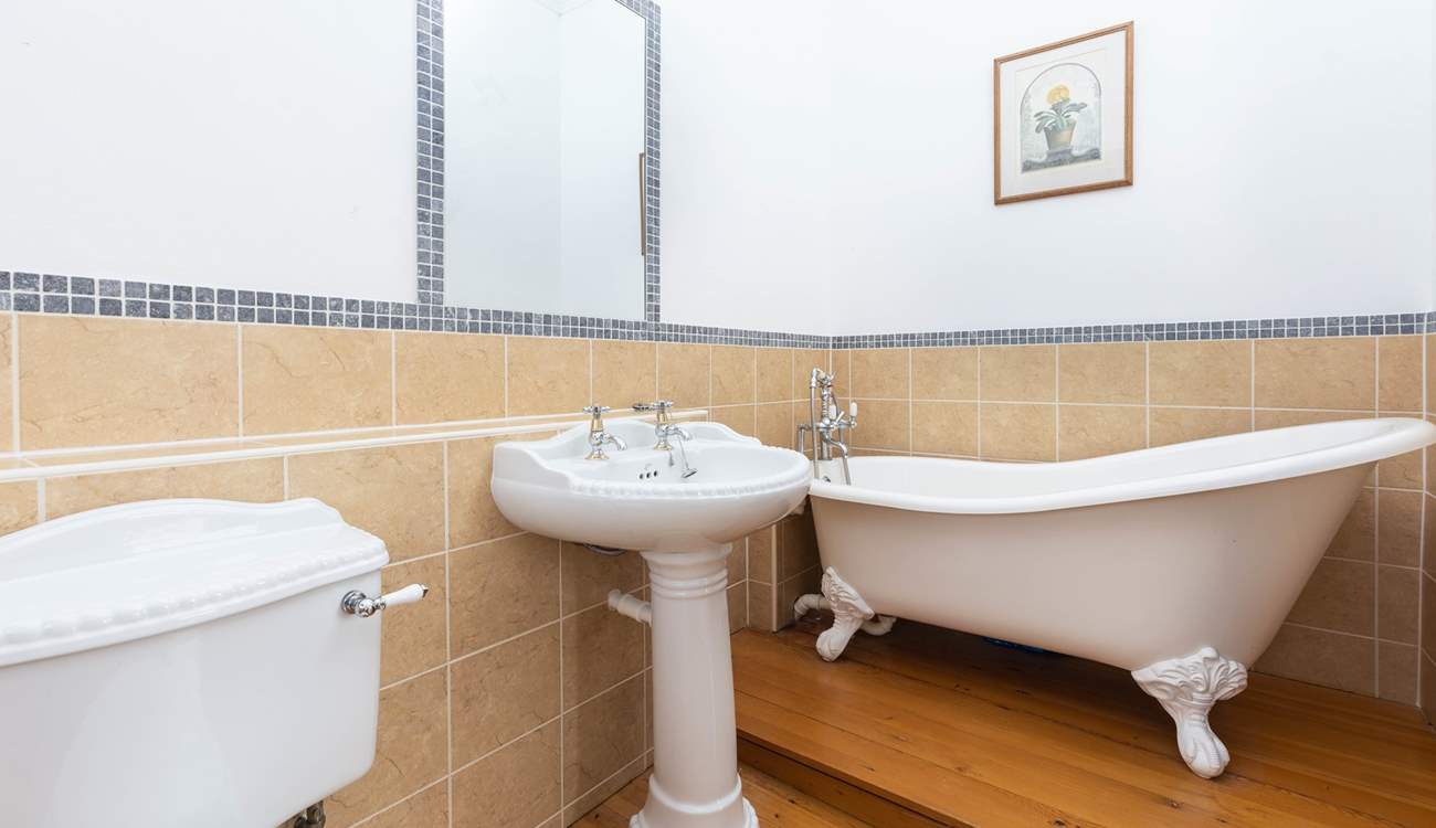 An indulgent free-standing bath sits in the corner of bedroom two's en suite bathroom.