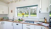 A well-equipped kitchen with a pretty view of the spacious garden. 
