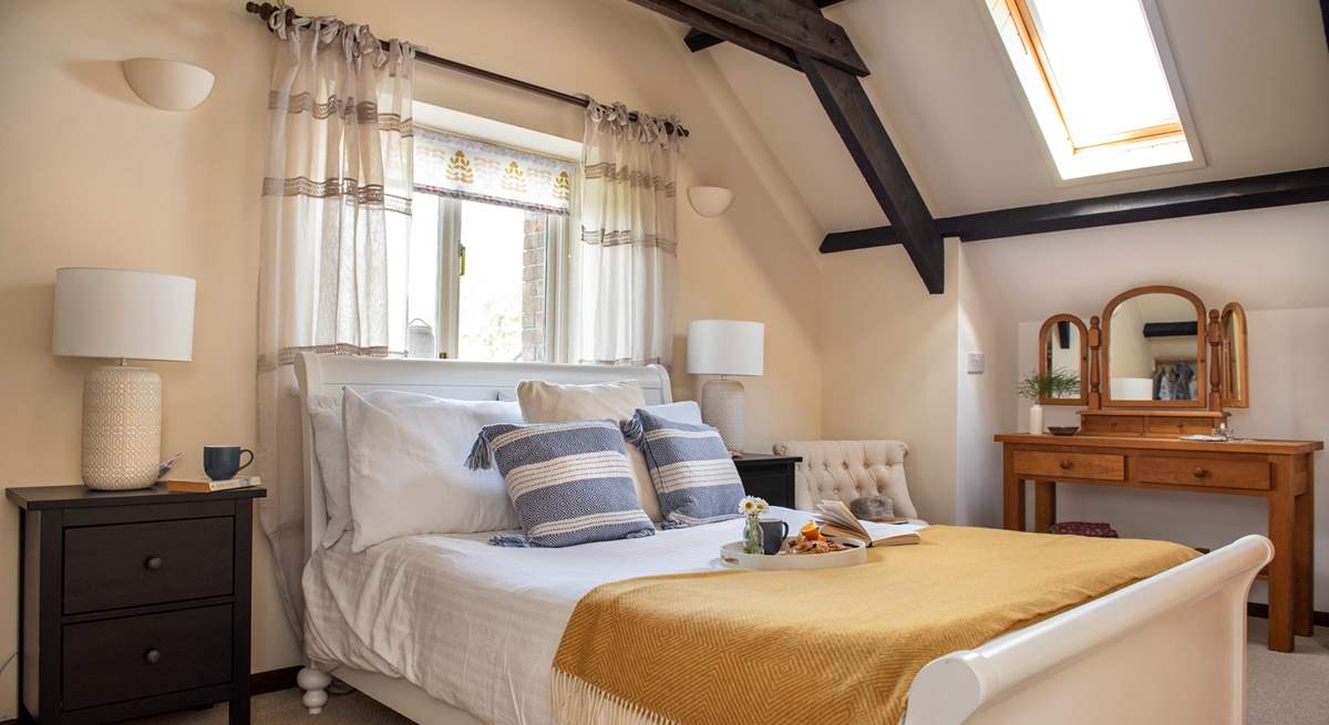 The spacious double bedroom sits on the first floor and the exposed beams add to the overall character and charm