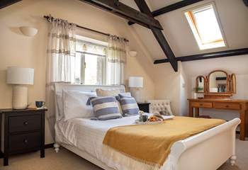 The spacious double bedroom sits on the first floor and the exposed beams add to the overall character and charm