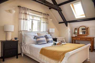 The spacious double bedroom sits on the first floor and the exposed beams add to the overall character and charm