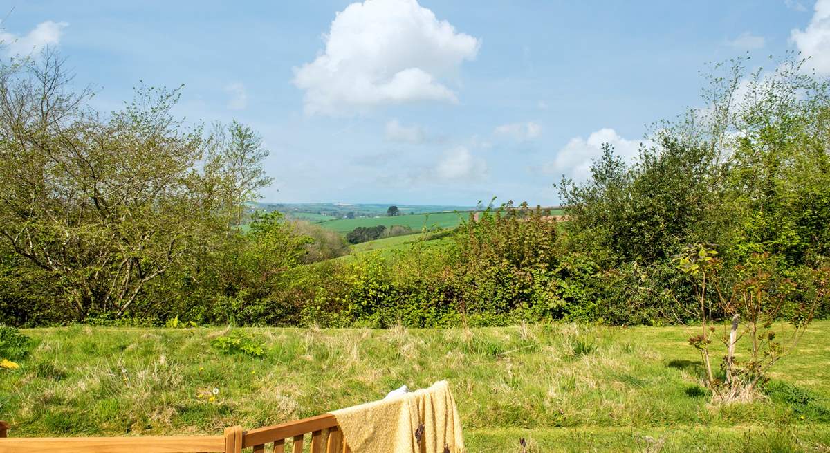 In the wild meadow garden and orchard the view is stunning and the garden bench has been positioned perfectly to take full advantage