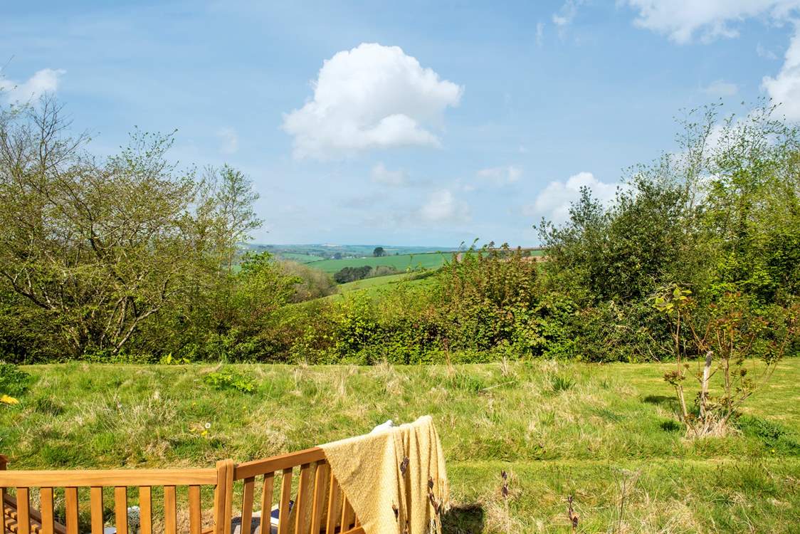 In the wild meadow garden and orchard the view is stunning and the garden bench has been positioned perfectly to take full advantage