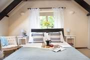 Lovely linen and gorgeous cushions adorn the beds