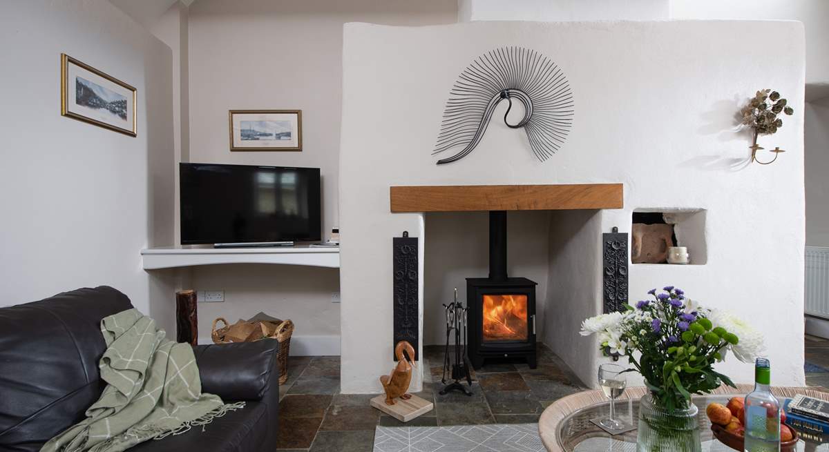 The gorgeous wood-burner sits in a fabulous feature fireplace.