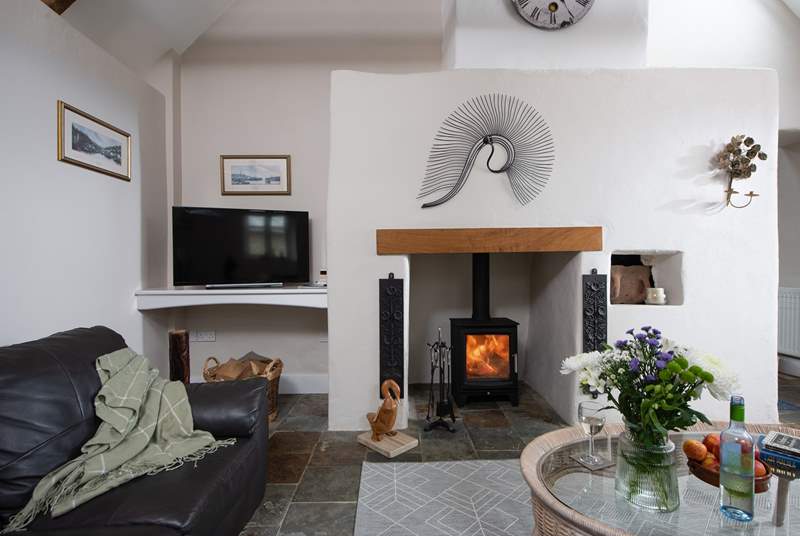 The gorgeous wood-burner sits in a fabulous feature fireplace.