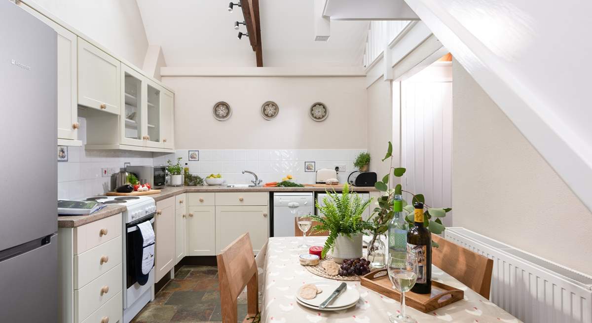 Double height ceilings and Velux windows bring light into the kitchen/diner.