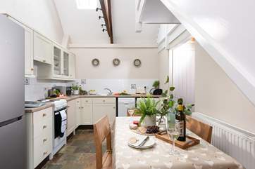 Double height ceilings and Velux windows bring light into the kitchen/diner.