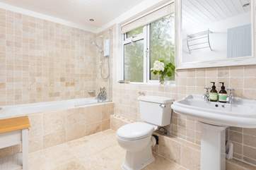 The spacious family bathroom has a bath with shower over.