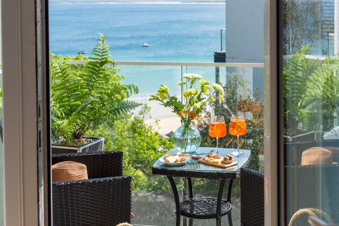 The balcony looks out over the turquoise waters of St Ives bay towards Godrevy lighthouse. 