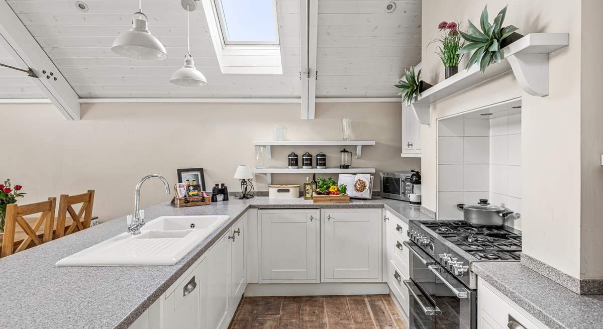 A crisp modern kitchen sits at the end of the space.