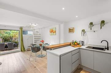 The space comes equipped with another Smart TV and sliding doors to the garden.